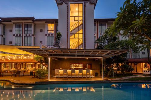 an exterior view of a hotel with a swimming pool at Prime Plaza Hotel Sanur – Bali in Sanur