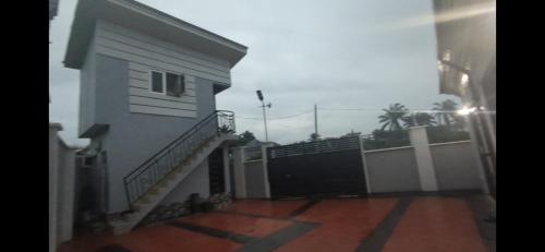 a house with a black gate and a fence at Nexcon Apartments in Uyo