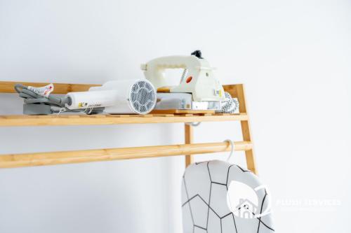 a sewing machine sitting on top of a wooden shelf at Gaia Residences by Plush in Rawang