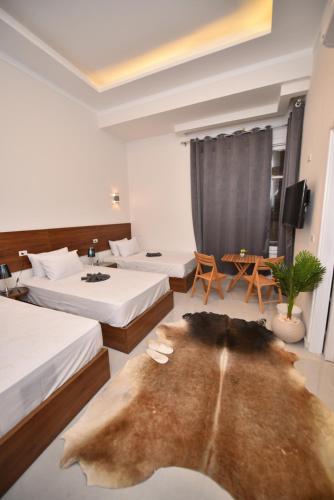 a hotel room with two beds and a table at family suites cairo downtown in Cairo