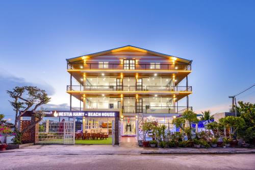 a large building with lights on top of it at Hestia HaMy Beach House in Hoi An