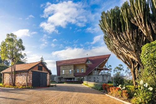 a large house with a red roof at Kirimara Woodlands, Nanyuki in Nanyuki