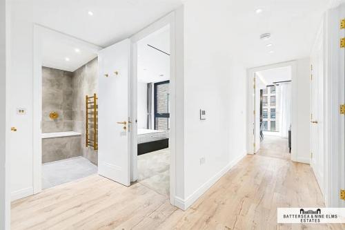 a white bathroom with white walls and wooden floors at 250 City Road 2 Bollinder Place EC1V 2AH 2bed LUXURY apartments-this is full address in London