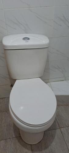a white toilet sitting in a bathroom at Studio Space in Nairobi