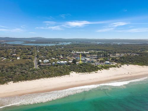 an aerial view of the beach and the ocean at Opposite Bennetts Beach in Hawks Nest