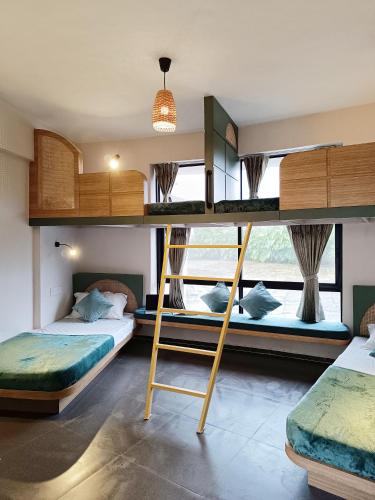 a bedroom with two bunk beds and a window at Voyage Zo Lonavala in Lonavala