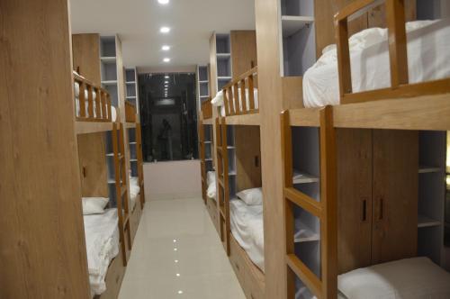 a hallway with many bunk beds in a room at The Rividium Hotel in Deoghar