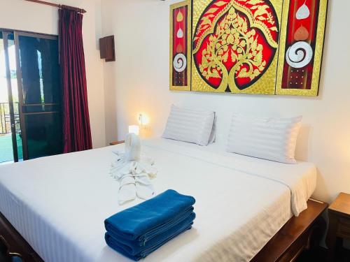 a bedroom with two beds with blue bags on them at Boomerang Village Resort Kata in Kata Beach