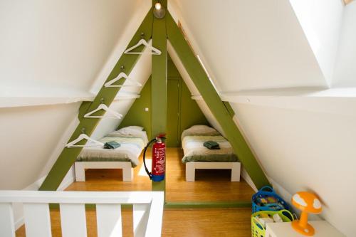 a childs room with two beds in a attic at Vakantievilla 3 Beaufort in Nieuwpoort