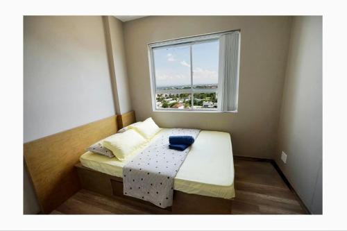 a small room with a small bed with a window at N's house in Phan Thiet