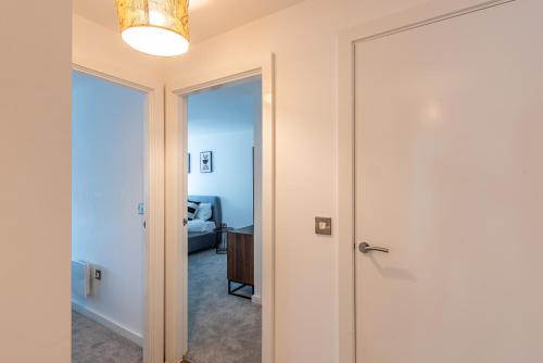 a hallway with a door leading to a bedroom at Bayut1 in Manchester