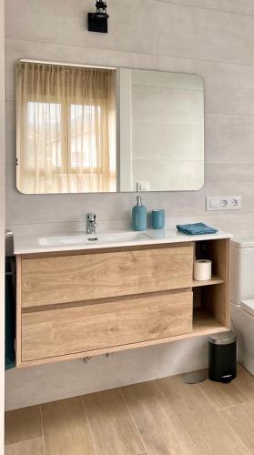 a bathroom with a sink and a mirror at Azul Andrin in Andrín