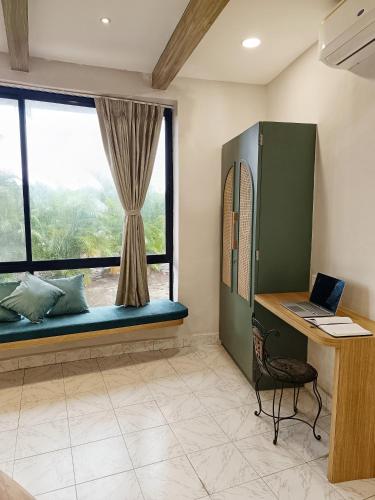 a room with a window with a desk and a laptop at Voyage Zo Lonavala in Lonavala