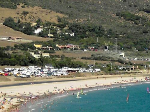 a beach with a bunch of people on it at Hotel Copacabana Tarifa Beach in Tarifa