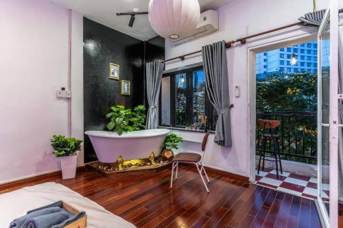 a bathroom with a tub and a large window at Saigon Hideout New World View in Ho Chi Minh City