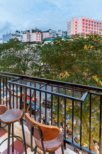 a balcony with chairs and a view of a city at Saigon Hideout New World View in Ho Chi Minh City