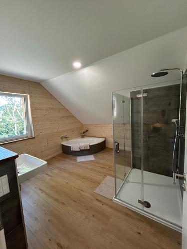 a bathroom with a shower and a bath tub at Ferienhaus Haselnuss in Schleiden