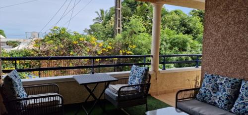 two chairs and a table on a balcony with a view at Chez Gerard in Saint-Pierre