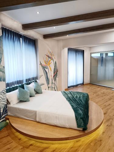 a bedroom with a large white bed with blue curtains at Voyage Zo Lonavala in Lonavala