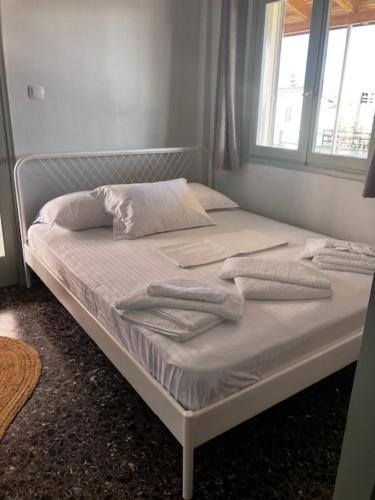 a bed with towels on it in a bedroom at Star lounge in Preveza