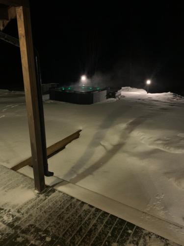 a snow covered parking lot at night at Mitt paradis in Bardufoss