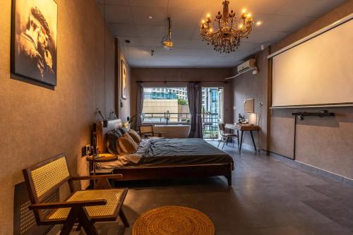 a bedroom with a bed and a chandelier at Saigon Hideout New World View in Ho Chi Minh City