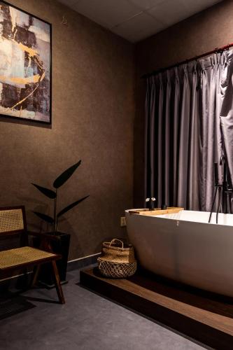 a bathroom with a bath tub in a room at Saigon Hideout New World View in Ho Chi Minh City