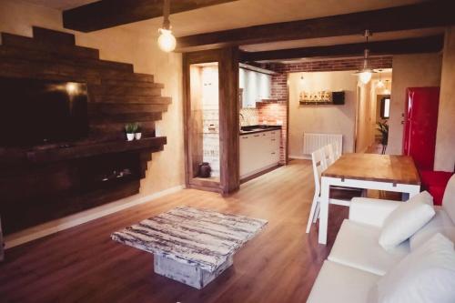 a living room with a white couch and a table at Luxury Danna Plaza Mayor in Cuenca