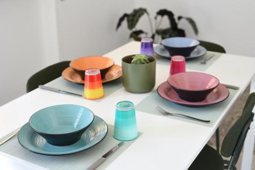 a table with plates and bowls on top of it at AR apartments in Lamezia Terme