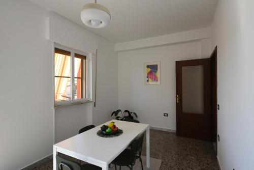 a white table with a bowl of fruit on it at AR apartments in Lamezia Terme