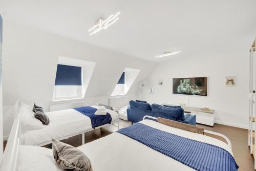 a room with three beds and a couch at Dartford Town 3 Bed by Harlington in Dartford