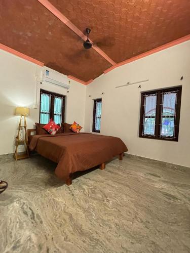 a bedroom with a large bed in a room at Kulture KonnectT in Varkala