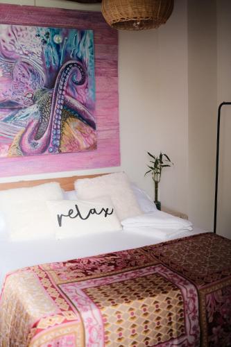 a bedroom with a bed with a painting on the wall at Cristal Blue Barú in Baru