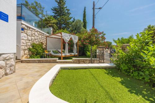 a garden with a lawn and a tent at Amarie in Dramalj