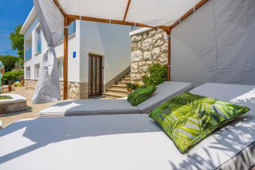a bed with two pillows on a patio at Amarie in Dramalj