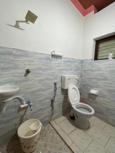 a bathroom with a toilet and a sink at Kulture KonnectT in Varkala