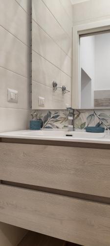 a bathroom with a sink and a mirror at A Molfetta in Molfetta