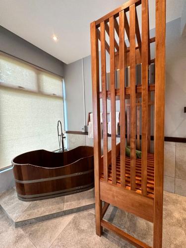 a bathroom with a bath tub and a sink at Ambong Pool Villas - Private Pool in Pantai Cenang
