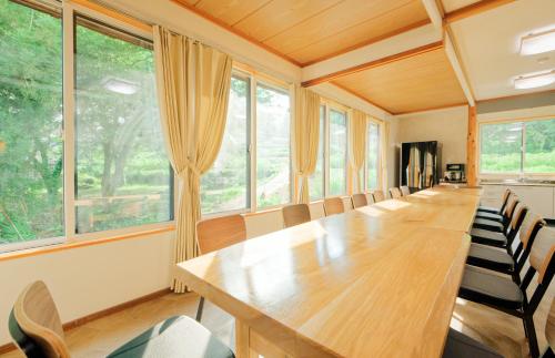 a large conference room with a long table and chairs at Togari Inn Suites in Iiyama