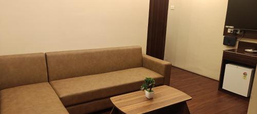 a living room with a couch and a coffee table at XCELSIOR HOTEL AND SPA by ROH in Shillong