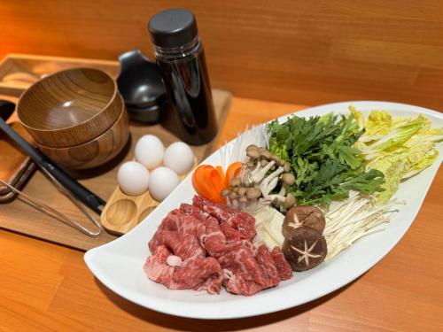 a plate of food with meat and vegetables on a table at Towadakohan Sakura in Towada