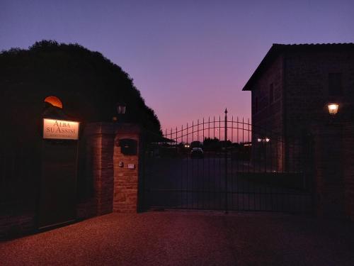 a building with a sign on it at night at Alba su Assisi in Petrignano