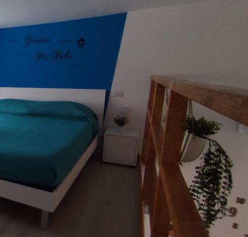 a room with a bed with a blue sign on it at A Molfetta in Molfetta