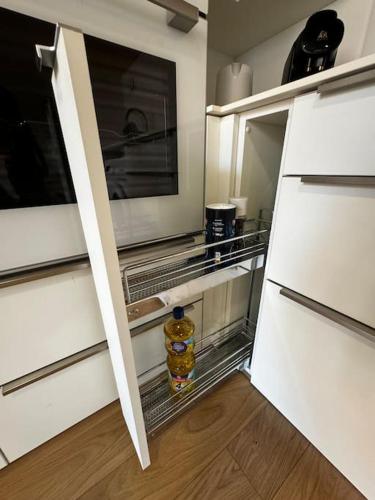 - une cuisine avec un réfrigérateur ouvert et une bouteille dans l'établissement Charmant T3 - Place Colbert - Lyon Centre, à Lyon