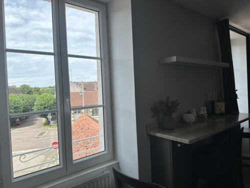 a window in a room with a view of a street at La Maison du Chablisien in Chablis