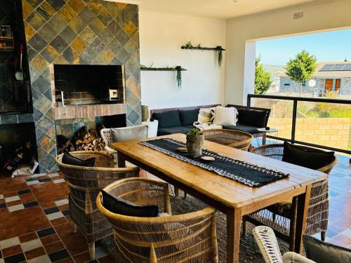 a living room with a table and a fireplace at Round Robben in Langebaan