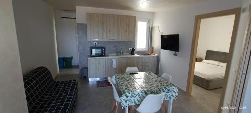 a small kitchen with a table and chairs in a room at Casa vasto via croci in Marina di Montenero