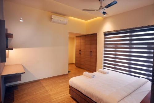 a bedroom with a large bed and a window at Sannidhi Homes Palakkad in Palakkad