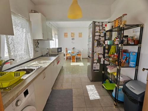 a kitchen with a sink and a refrigerator at Guest House Casa Ramos on the Strip in Albufeira