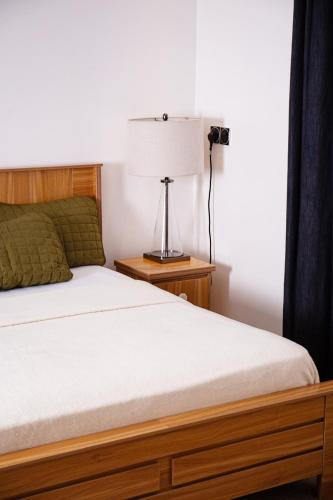 a bedroom with a bed and a lamp on a table at Chumbys in Lagos